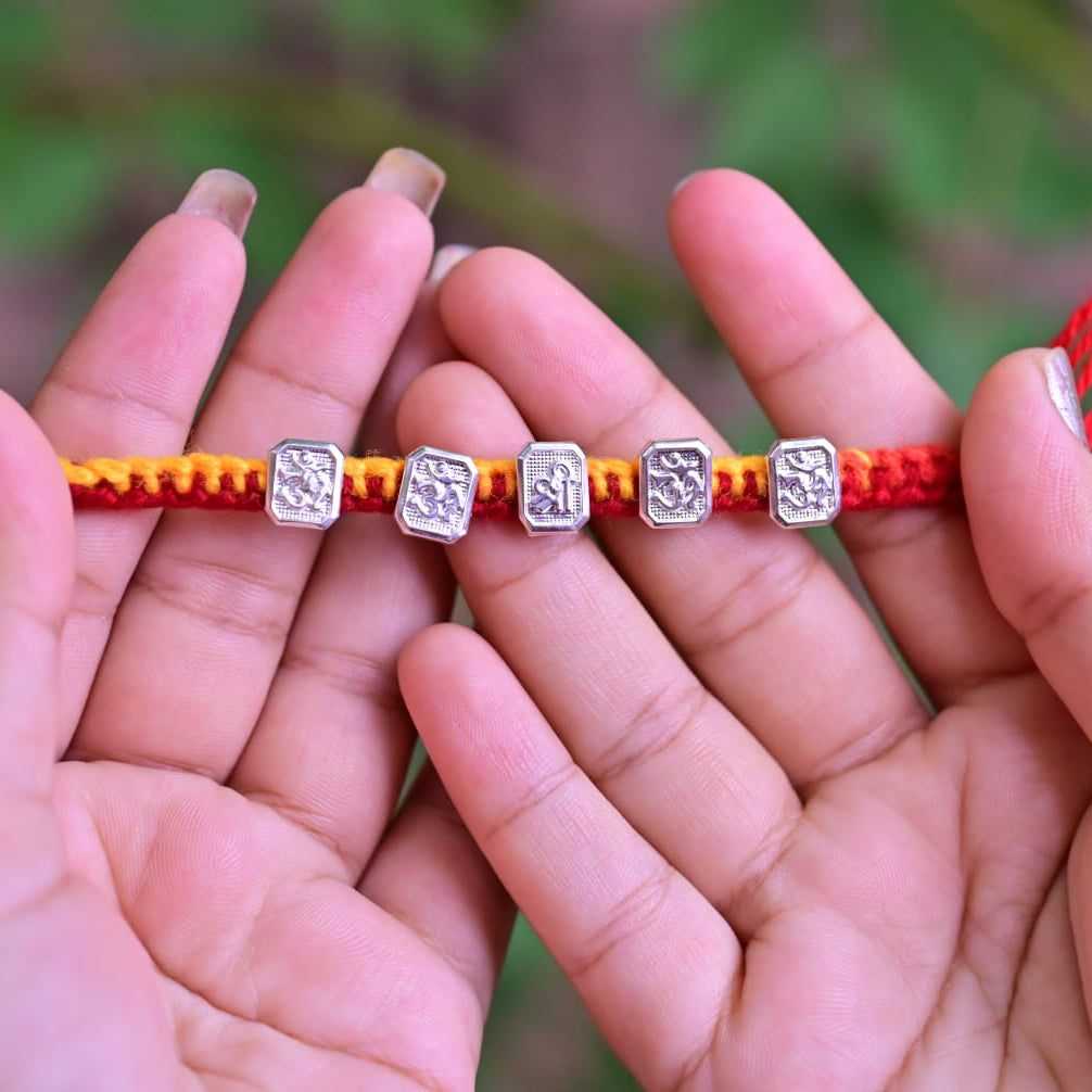 Elegant Silver Om Rakhi for Auspicious Bond