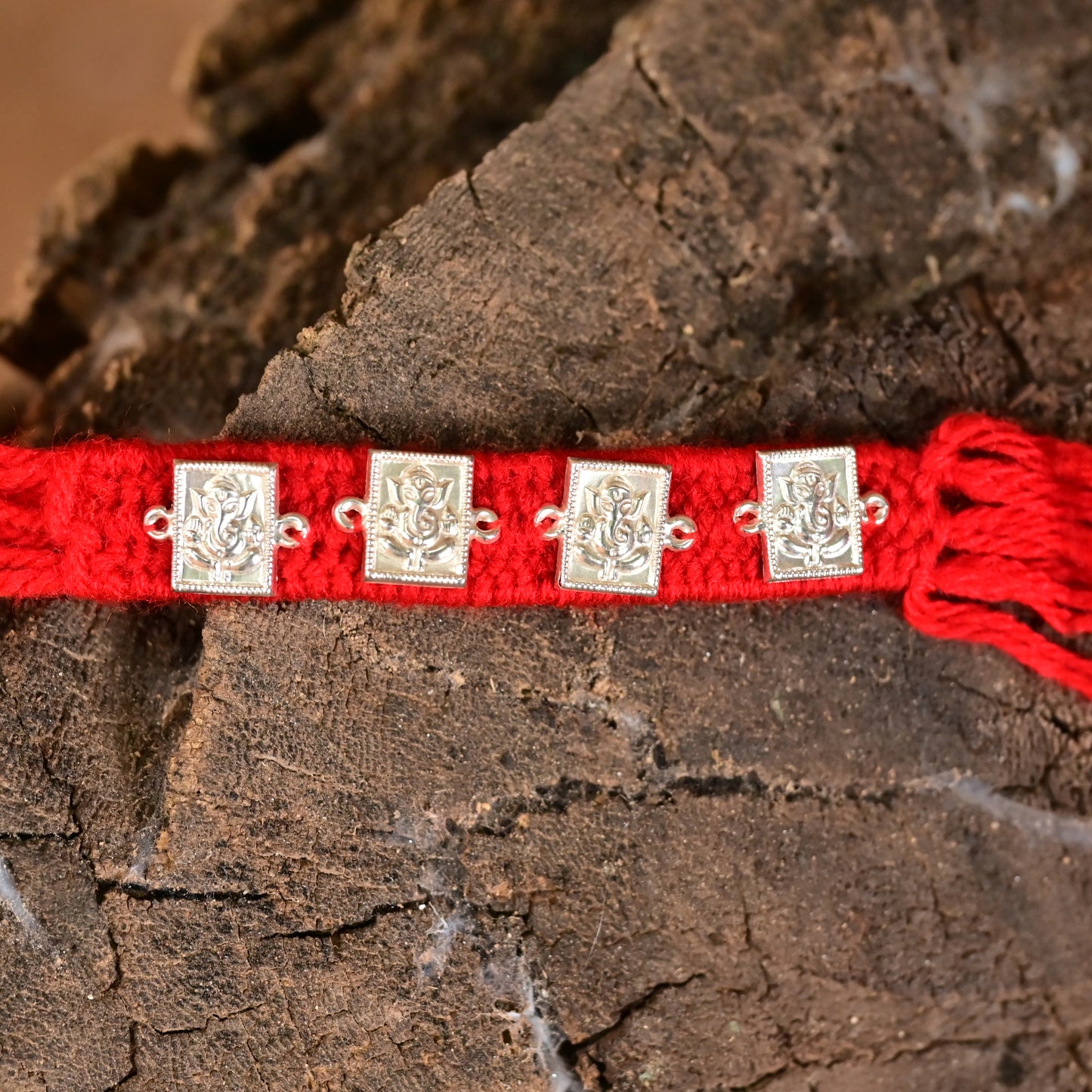 Traditional Silver Ganesh Rakhi on Red Thread