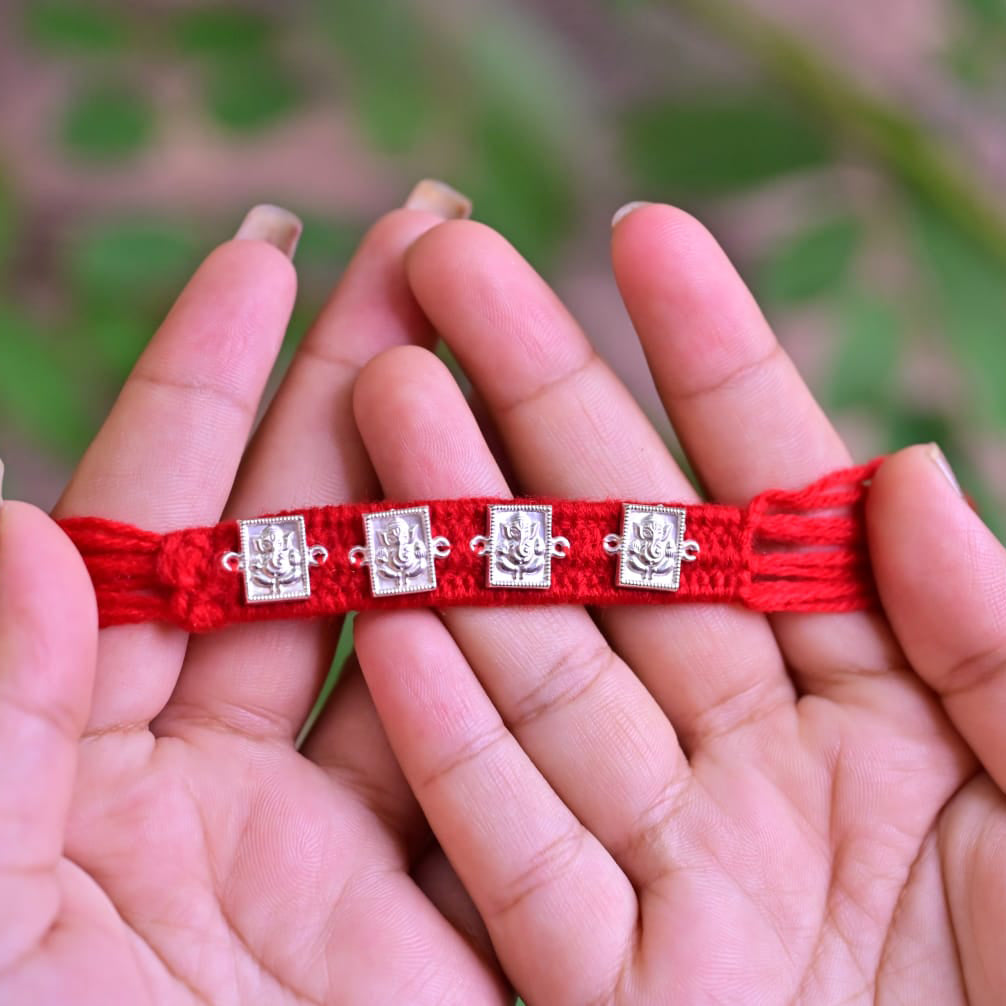 Traditional Silver Ganesh Rakhi on Red Thread